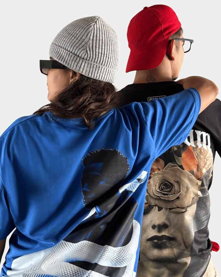 Two people wearing graphic oversized t-shirts including Daydream Bloom oversized t-shirt by Gully Projekt