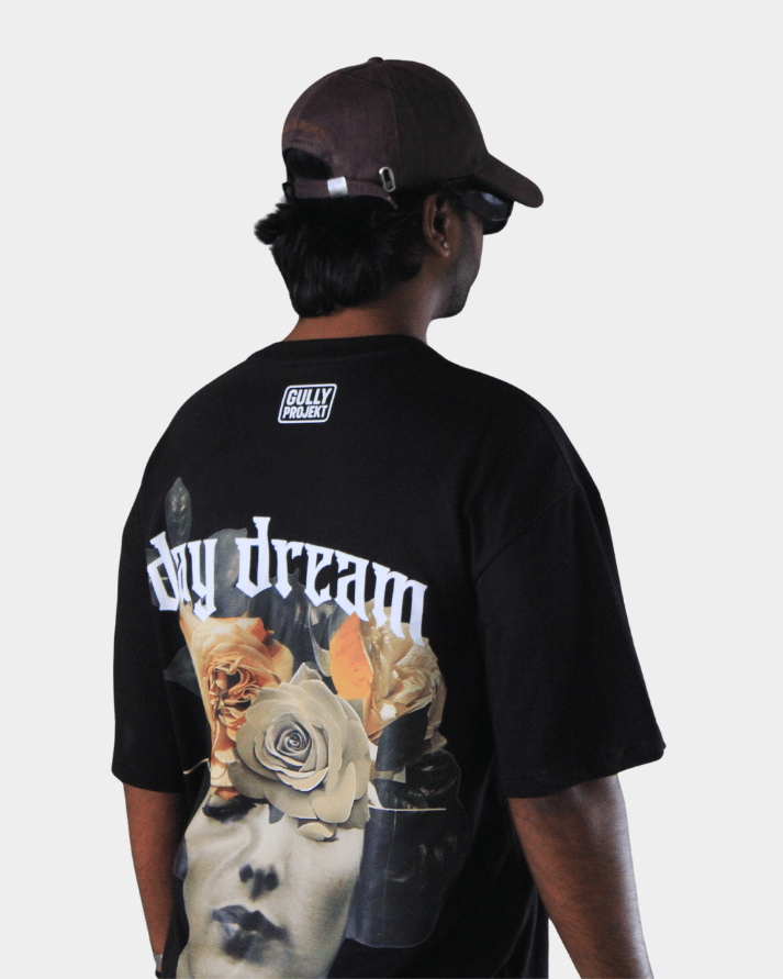 Back view of man wearing Gully Projekt Daydream Bloom oversized t-shirt with artistic floral graphic in black