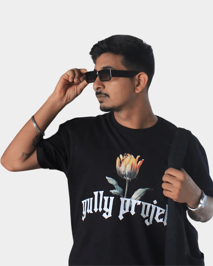 Man wearing black Daydream Bloom oversized t-shirt by Gully Projekt with floral design and logo